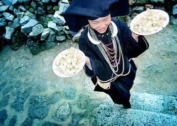 Strict observance of traditional dress requires Zhuang women to wear black head scarves.