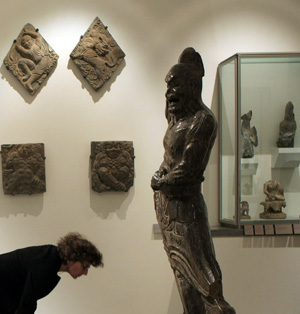 A visitor watches the items on display in Guimet Museum of Paris, France, Nov. 18, 2008.
