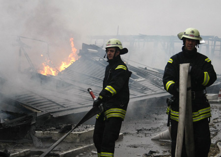 Fire fighters work on the scene of a fire at the military section of Berlin's Tegel airport November 20, 2008. A large fire broke out at the military section of Berlin's Tegel airport on Thursday, prompting authorities to divert flights elsewhere. 