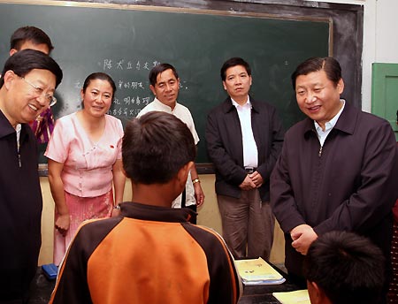 Chinese Vice President Xi Jinping (R) talks with a pupil at Man'en Jiuyi School of Man'en Village in Menghai County, southwest China's Yunnan Province, Nov. 17, 2008. Xi Jinping made an inspection in Yunnan Province on Nov. 17-20. 