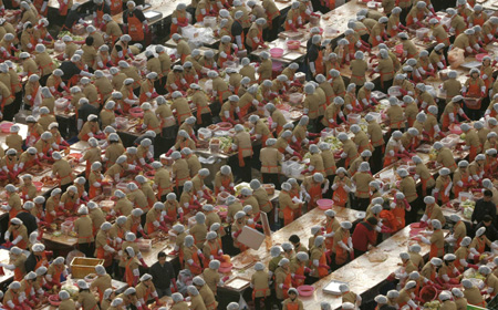 Employees of Korea Yakult make the traditional side dish 'kimchi', or fermented cabbage, during a donation drive in front of Seoul city hall November 20, 2008. About 5,000 of the company's employees participated in the event on Thursday, held in six cities including Seoul, Busan and Incheon, to make kimchi from 120,000 cabbages to donate to the needy during the winter season. 