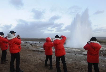 Visitors take photos of famous geyser in north Reykjavik, Iceland, Nov. 19, 2008. Geothermal energy is very often used for heating and production of electricity in Iceland. The energy is so inexpensive that in the wintertime, some pavements in Reykjavík are heated. In Iceland, there are five major geothermal power plants, which produce 26.5 percent of the country's electricity.