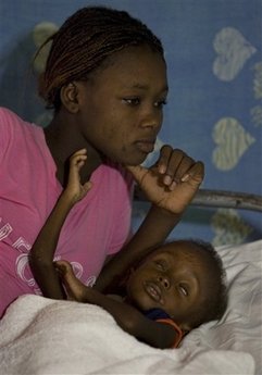 Sabine lies with her son Pierre Davidson, 3, who suffers from malnutrition, in the Doctors Without Borders hospital in Port-au-Prince, Wednesday, Nov. 19, 2008. 