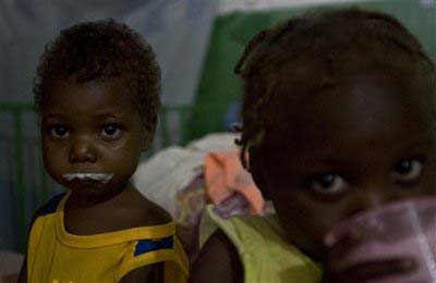 Two children who suffer from malnutrition sit in the Doctors Without Borders hospital in Port-au-Prince, Wednesday, November 19, 2008. 