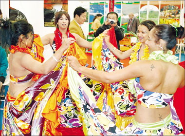 Women from Mauritius dance at the China International Travel Mart 2008, which kicked off in Shanghai yesterday. More than 4,000 companies from 106 countries and regions are taking part in the four-day event despite the global gloom. It attracted more than 10,000 visitors on opening day. [Photo: Shanghai Daily]