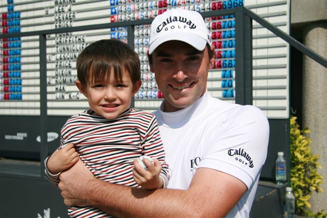 Oliver Wilson took time out after his successful round to pose for a photo with a young fan.