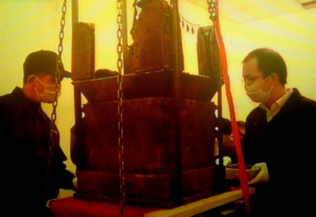 A video grab show two archeologists remove the miniature pagoda, which is believed to contain a part of Buddha's body in Nanjing, Jiangsu province November 22, 2008. 