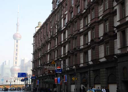 Photo taken on Nov. 21, 2008 shows the southern building of Peace Hotel, the landmark construction of nearly 100-year history, at the Bund in Shanghai, China. The reconstruction project of the Peace Hotel has kicked off recently, whose northern and southern buildings would be reconstructed to a grand hotel and an art center respectively. It is predicted that the Peace Hotel will accomodate public guests before the Shanghai 2010 World Expo. (Xinhua)