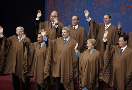 Leaders of member economies pose for a group photo while wearing typical ponchos from Peru, during a break in the Asia-Pacific Economic Cooperation (APEC) summit in Lima, November 23, 2008. 