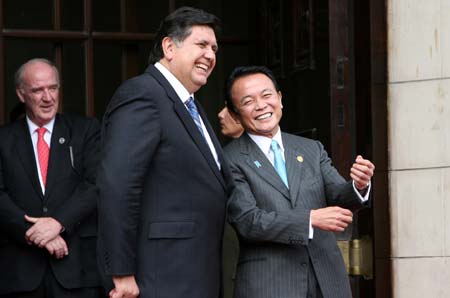 Japanese Prime Minister Taro Aso (R) is seen off by Peruvian President Alan Garcia at the Peruvian presidential palace after the conclusion of the 16th Economic Leaders' Meeting of the Asia-Pacific Economic Cooperation (APEC), in Lima, capital of Peru, Nov. 23, 2008. The 16th APEC Economic Leaders' Meeting concluded on Sunday as leaders from APEC member economies vowed to boost regional economic integration and food security, and to combat climate change and corruption, in a declaration issued after the two-day meeting in Lima.