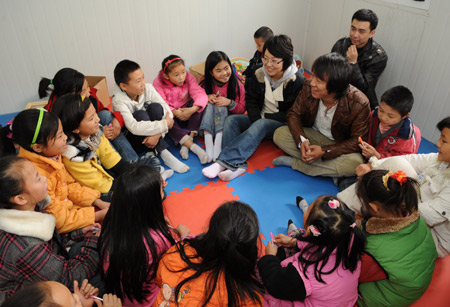 Chinese actress Yan Ni and actor Huang Bo talk with kids at a child friendship home, part of the children&apos;s protection program to quake-hit Sichuan, in Jiangyou, southwest China&apos;s Sichuan Province Nov. 23, 2008. 