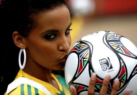 Miss South Africa Tansey Coetzee kisses the official ball at Ellis Park stadium, one of the venues for the 2009 FIFA Confederation Cup in Johannesburg, November 20, 2008. 