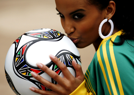 Miss South Africa Tansey Coetzee kisses the official ball at Ellis Park stadium, one of the venues for the 2009 FIFA Confederation Cup in Johannesburg, November 20, 2008. 