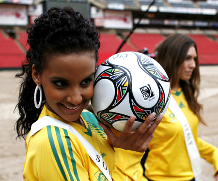 Miss South Africa Tansey Coetzee poses with the official ball at Ellis Park stadium, one of the venues for the 2009 FIFA Confederation Cup in Johannesburg, November 20, 2008. 