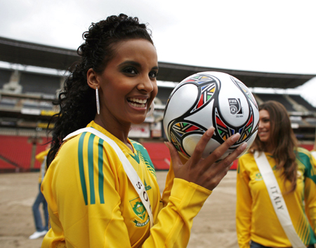 Miss South Africa Tansey Coetzee poses with the official ball at Ellis Park stadium, one of the venues for the 2009 FIFA Confederation Cup in Johannesburg, November 20, 2008. 