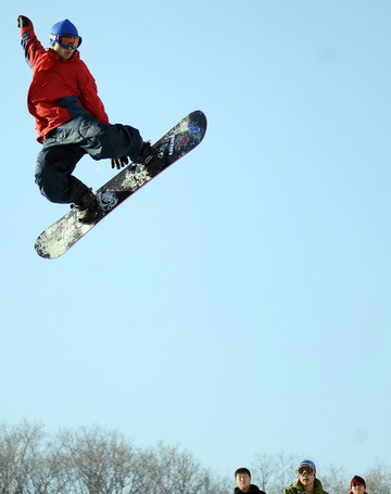 A man performs a jump during the opening ceremony of a snowboard park in Lotus Hill of Changchun, capital of northeast China's Jilin Province November 23, 2008. 