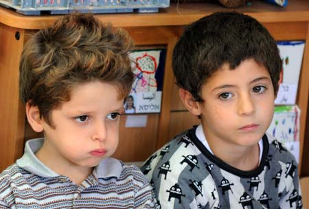 An Arab boy (R) and a Jewish boy sit together at the kindergarten of a Jewish-Arab school in Kafar Qara of Wadi Ara Region, north Israel, Nov. 24, 2008. Some 120 Arab students and 80 Jewish students from kindergarten to grade six study at the school, which was founded in 2003. Students of the school are co-taught by Jewish and Arab teachers in both Hebrew and Arabic.