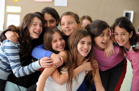 Jewish and Arab students play together at a Jewish-Arab school in Kafar Qara of Wadi Ara Region, north Israel, Nov. 24, 2008. Some 120 Arab students and 80 Jewish students from kindergarten to grade six study at the school, which was founded in 2003. Students of the school are co-taught by Jewish and Arab teachers in both Hebrew and Arabic.