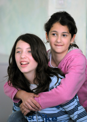 An Arab student plays with a Jewish student at a Jewish-Arab school in Kafar Qara of Wadi Ara Region, north Israel, Nov. 24, 2008. Some 120 Arab students and 80 Jewish students from kindergarten to grade six study at the school, which was founded in 2003. Students of the school are co-taught by Jewish and Arab teachers in both Hebrew and Arabic. 