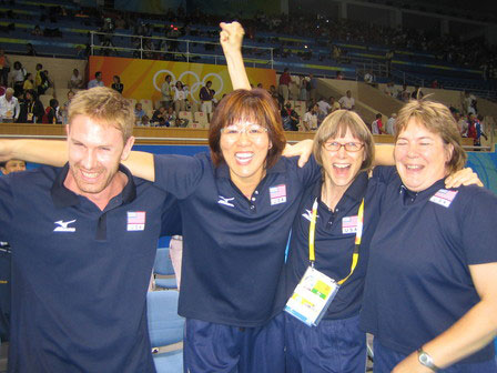 Lang Ping celebrates Team USA's victory over Cuba in the 2008 Olympic Games semifinals with Tom Hogan (left), Diane French (second to right) and Sue Woodstra (right). [USA Volleyball] 