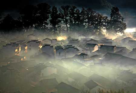 Photo taken on Nov. 25, 2008 shows the Shicheng Village hidden in the mist during the early morning in Wuyuan City, east China's Jiangxi Province. [Xinhua] 