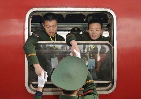 Ex-servicemen bid farewell to their companion after completing their military service, at a railway station in Hefei, Anhui province November 25, 2008.