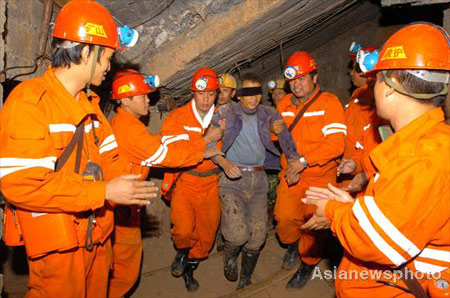 Rescuers send a miner to safety after he was trapped under a tungsten mine accident site for over 80 hours in Longnan County of East China's Jiangxi Province November 24, 2008. All of the four trapped miners have been rescued and sent to hospital for heath check. 