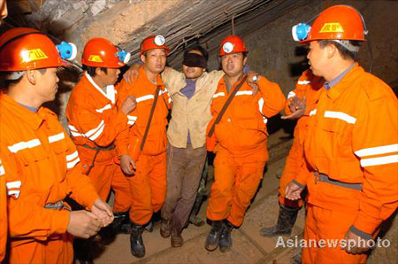 Rescuers send a miner to safety after he was trapped under a tungsten mine accident site for over 80 hours in Longnan County of East China's Jiangxi Province November 24, 2008. All of the four trapped miners have been rescued and sent to hospital for heath check. 