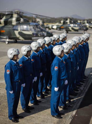 The outgoing pilots of military helicopters of People's Liberation Army garrison troops in the Hong Kong Special Administrative Region (HKSAR) stand in their formation before leaving Skek Kong Barracks of Hong Kong for their base in the Chinese mainland, Nov. 25, 2008. 