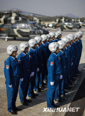 The outgoing pilots of military helicopters of People's Liberation Army garrison troops in the Hong Kong Special Administrative Region (HKSAR) stand in their formation before leaving Skek Kong Barracks of Hong Kong for their base in the Chinese mainland, Nov. 25, 2008. The Chinese People's Liberation Army garrison troops in HKSAR conducted on Tuesday its 11th troop rotation since it assumed Hong Kong's defense responsibility on July 1, 1997. (Xinhua Photo)