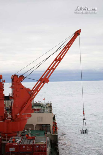 A crane on China's Antarctic icebreaker Xuelong is delivering aviation kerosene from containers to the parking apron on the deck on Wednesday, November 26, 2008. 