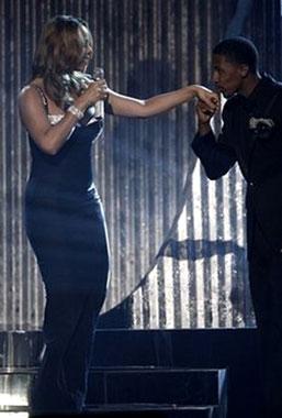 Nick Cannon, right, kisses Mariah Carey&apos;s hand at the American Music Awards in Los Angeles on Sunday, Nov. 23, 2008. [Matt Sayles/AP Photo] 