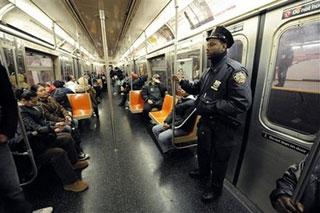 A New York police officer rides a subway train, in New York Wednesday Nov. 26, 2008.[Richard Drew/AP Photo] 