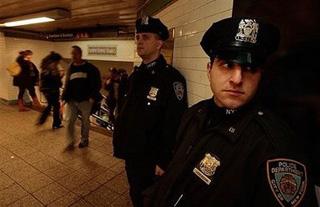 New York Police Department officers keep watch in part of the Times Square subway station in New York City. [Chris Hondros/Getty Images/AFP] 