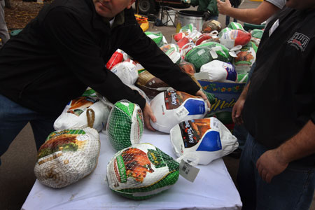 A volunteer prepares to give a turkey to a needy family at the annual Thanksgiving Banquet in a Box distribution November 25, 2008 in Denver, Colorado. The Denver Rescue Mission, the city's largest faith-based charity for the needy, planned to distribute food to some 1,200 families at the annual event ahead of Thanksgiving.