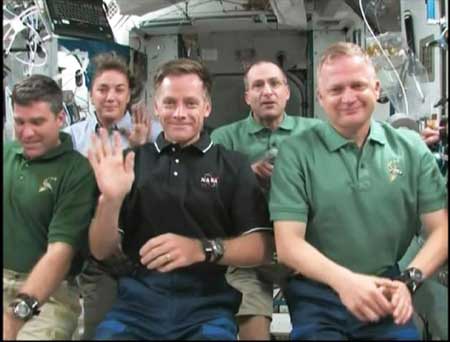 Space Shuttle Endeavour astronauts (L-R) Stephen Bowen, Heidemarie M. Stefanyshyn-Piper, Commander Christopher Ferguson, Donald R. Pettit and Pilot Eric Boe wave at the end of a news conference from the station in this view from NASA TV Nov. 25, 2008.