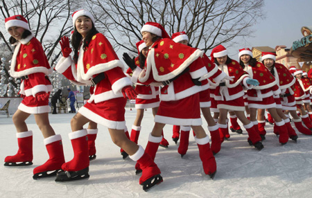 Employees of Everland amusement park ride a roller coaster wearing Santa Claus costumes at a Santa Academy class during a photo call at the amusement park, which is a part of the Samsung Group, in Yongin, South Korea on November 26, 2008. 