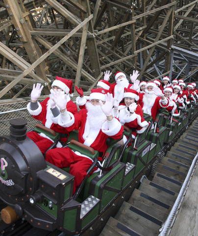 Employees of Everland amusement park ride a roller coaster wearing Santa Claus costumes at a Santa Academy class during a photo call at the amusement park, which is a part of the Samsung Group, in Yongin, South Korea on November 26, 2008. 