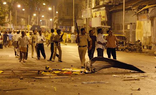 Indian policeman prepare to take position at the site of attack in Colaba area of Mumbai on November 27, 2008. Nearly 101 people were killed in a series of shootings and blasts across India's financial capital Mumbai late 26 November, the state government said. 
