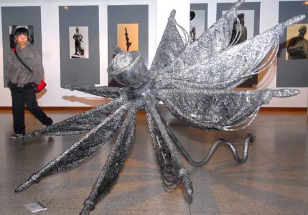 A visitor views a sculpture during an exhibition of Zhejiang's famous sculptors at the gallery of China Academy of Art in Hangzhou, capital of east China's Zhejiang Province, Nov. 26, 2008. The exhibition kicked off here Wednesday, displaying more than 60 works. 