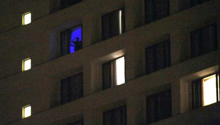 One terrorist observe the army's movement from a window in the Oberoi Hotel in Mumbai, India, Nov. 27, 2008. All hostages at Taj Hotel have been rescued, but there could still be more trapped at Oberoi Hotel, who the Indian security forces were trying to rescue.