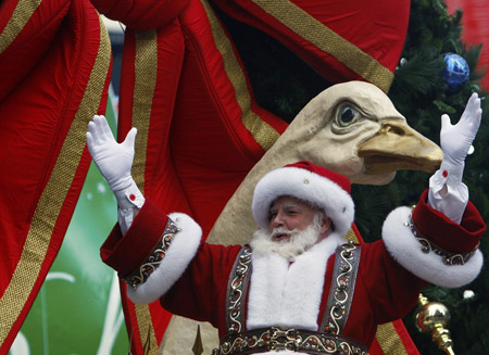 A man dressed as Santa Claus waves to the crowd during the Macy's Thanksgiving day parade in New York November 27, 2008.