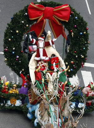 Santa Claus rides on a Christmas float through Times Square during the Macy's Thanksgiving Day Parade in New York, November 27, 2008. 