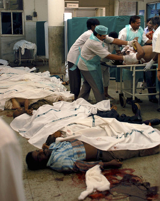 Hospital attendants place the body of a victim of Wednesday's shootings on a stretcher at the St. George hospital in Mumbai November 27, 2008.