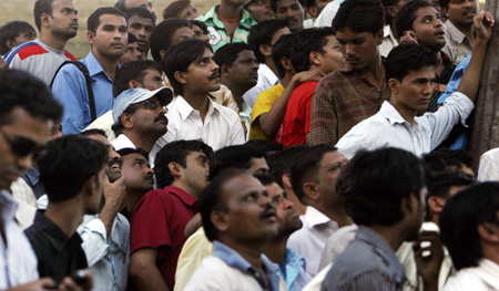 Onlookers stand outside Taj Hotel in Mumbai November 27, 2008. Elite Indian commandos fought room to room battles with Islamist militants inside two luxury hotels to save scores of people trapped or taken hostage, as the country's prime minister blamed neighbouring countries. 