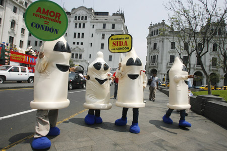 People dressed as a condoms take part in an AIDS and HIV prevention campaign in downtown Lima Nov. 28, 2008. The annual World AIDS Day will take place on Monday on Dec. 1. The banner reads: 'Responsible love = condom' and 'Protect from AIDS, use a condom.' [Xinhua/Reuters]