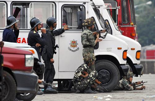 Indian Army soldiers take their positions outside the Taj Mahal Hotel in Mumbai on November 28, 2008. 