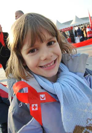 A child wears a red ribbon during a World AIDS Day event at the Olympic Green in Beijing, capital of China, Nov. 30, 2008.[Xinhua Photo]