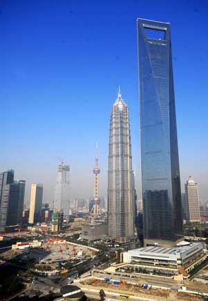 A photo taken on Nov. 29, 2008 shows the Shanghai World Financial Center, the Jinmao Tower and the building site of Shanghai Center (R to L) located in east China's Shanghai Municipality. [Xinhua]