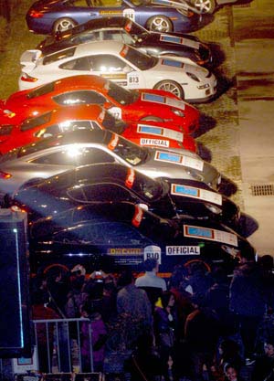 People look at Porsche roadsters in Wuhan, capital of central China's Hubei Province, Nov. 30, 2008. Forty-five Porsche roadsters taking part in a charity travel organized by Hong Kong Porsche Club were exhibited in Wuhan on Sunday.[Xinhua]